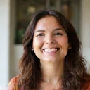 Portrait of a smiling woman, symbolizing client satisfaction.